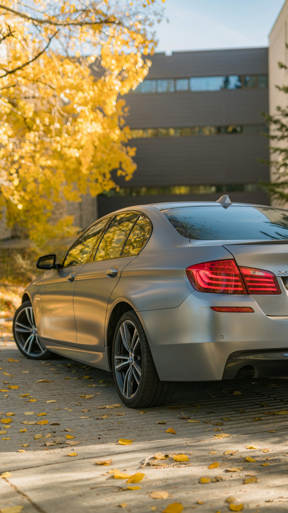 a silver car parked in front of a building