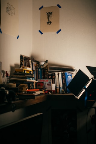 a laptop computer sitting on top of a wooden desk