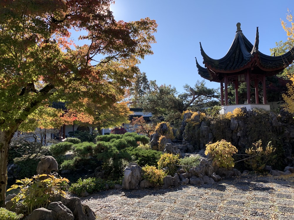 a pagoda in the middle of a garden with rocks and trees