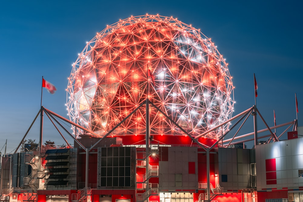 a large red and white ball on top of a building