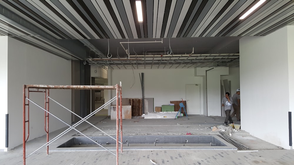 a man is standing in a large empty building