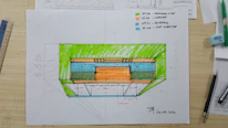 A detailed architectural sketch showing initial design concepts on paper.
