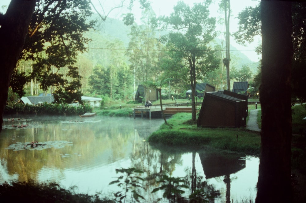 a body of water surrounded by trees and houses