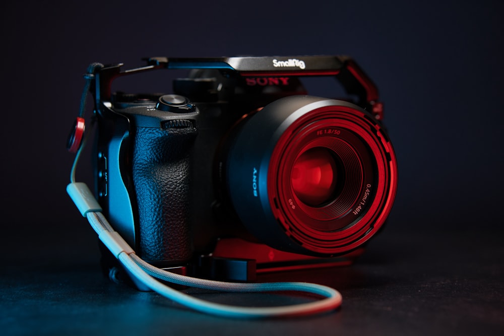a camera with a red lens on a black background
