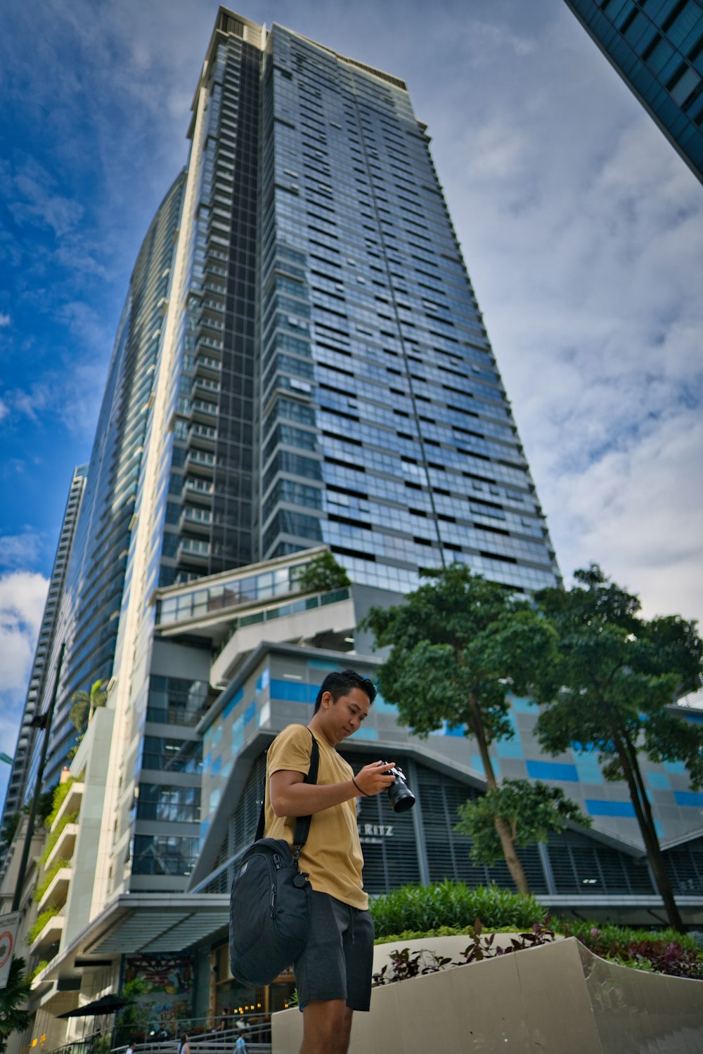 a man standing in front of a tall building