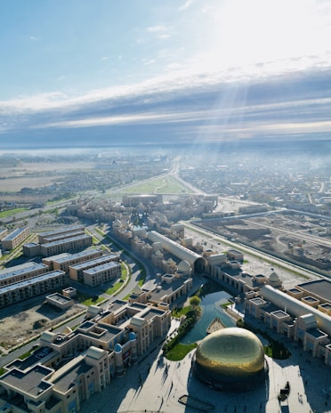 An aerial view of Buraq City showing neatly arranged houses and tree-lined streets.