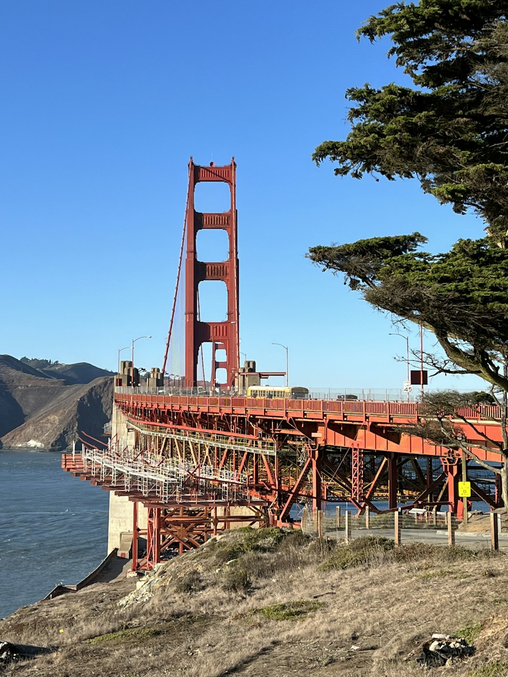 a view of the golden gate bridge from the side of a hill