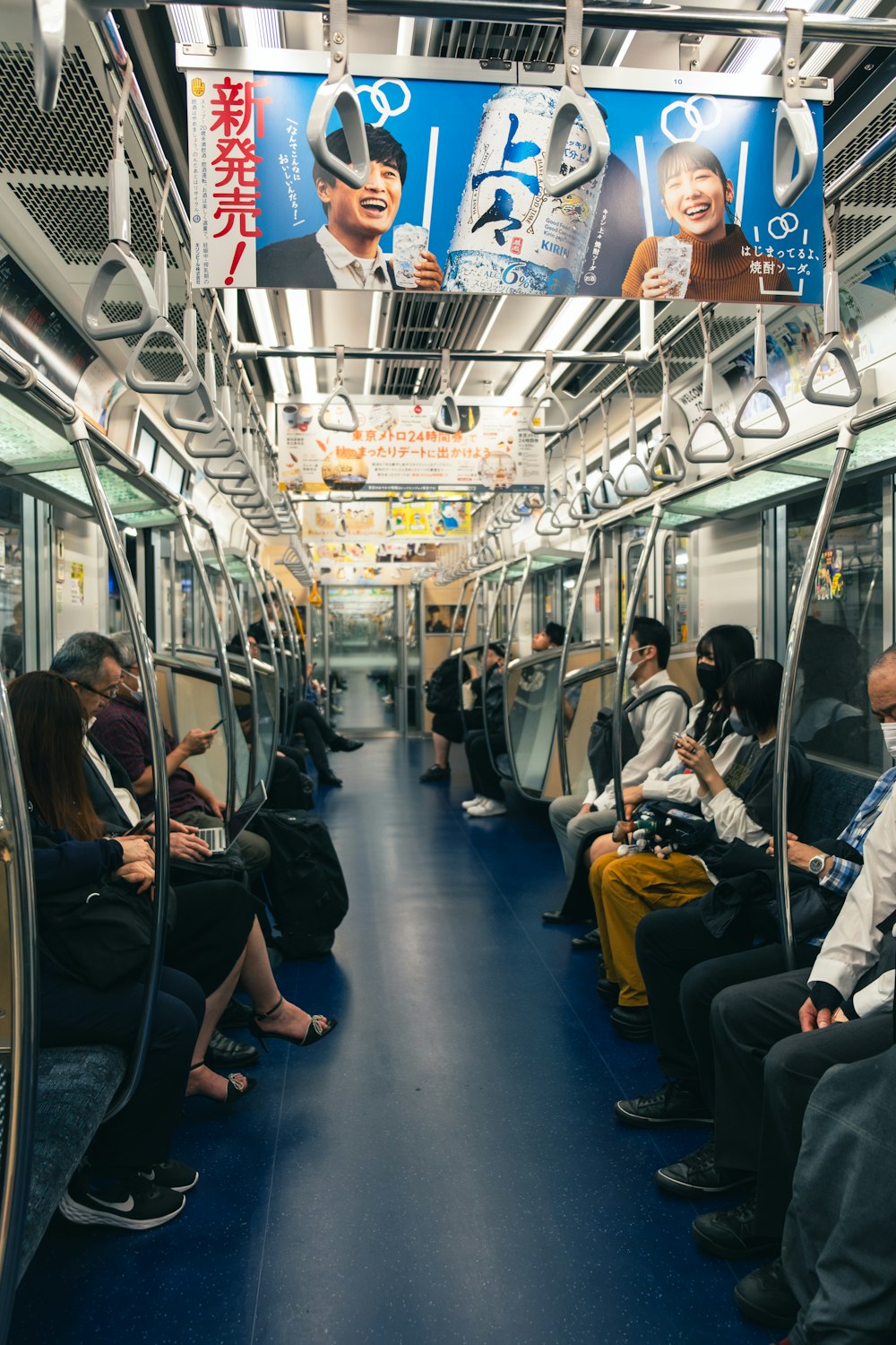 a group of people sitting on a subway train