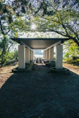 Pathway lined with wooden beams leading to the guest house entrance.