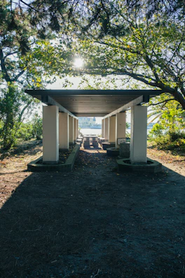 Pathway lined with wooden beams leading to the guest house entrance.