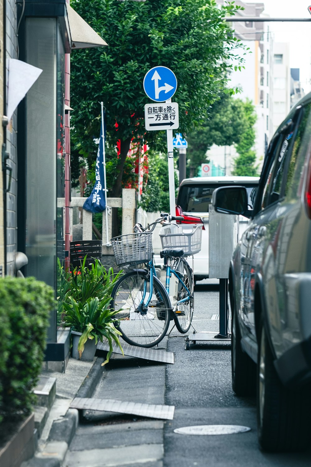 a bicycle parked next to a street sign