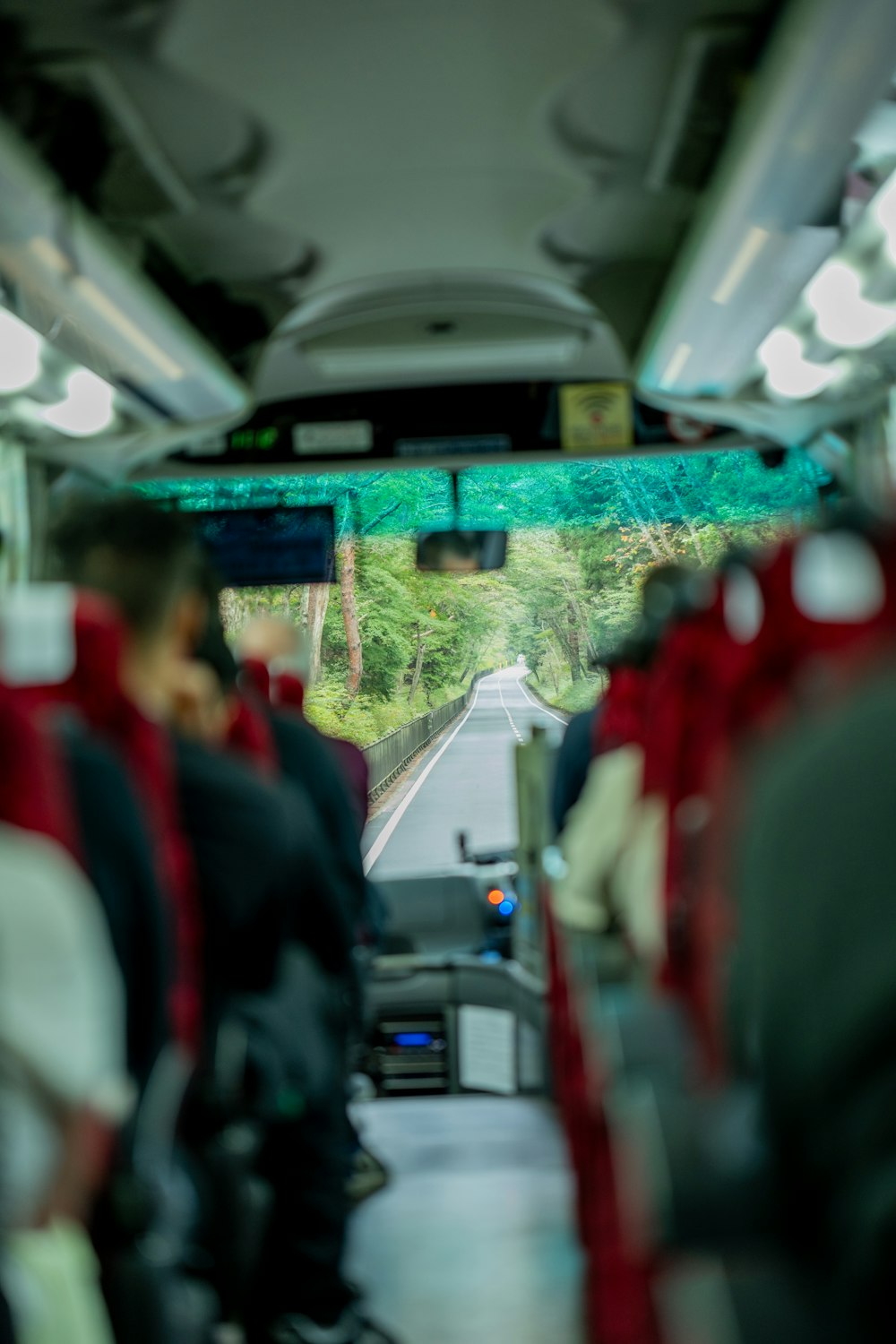 a view of the inside of a bus looking down the aisle