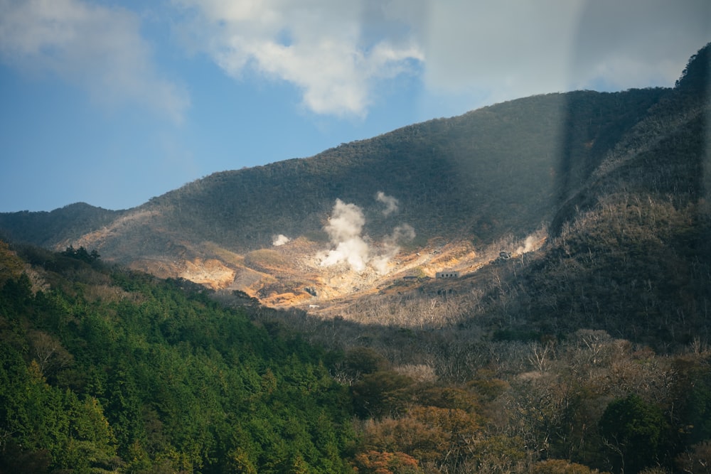 a view of a mountain with steam coming out of it