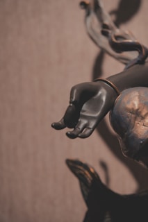 a close up of a figurine of a hand holding a chain