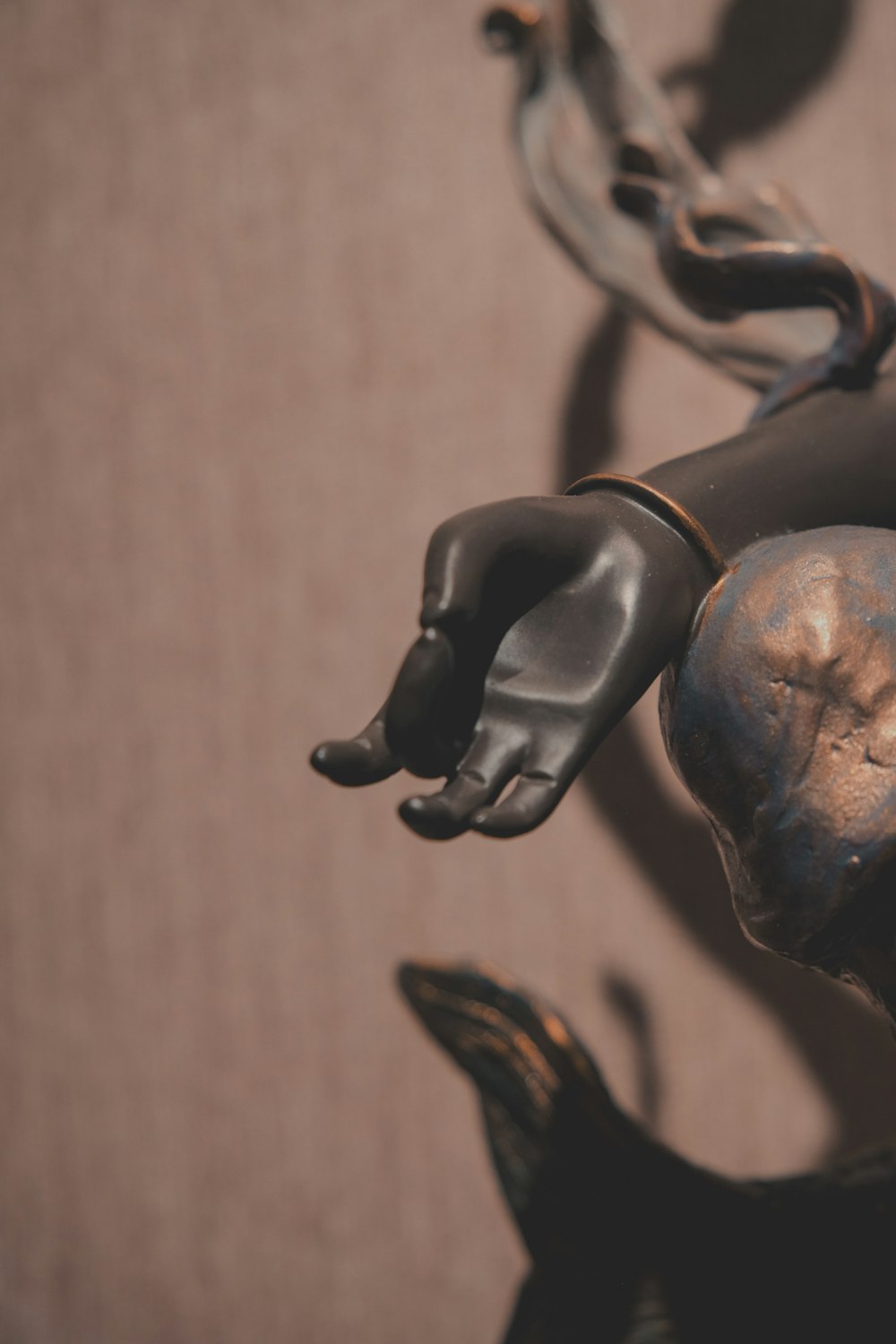 a close up of a figurine of a hand holding a chain