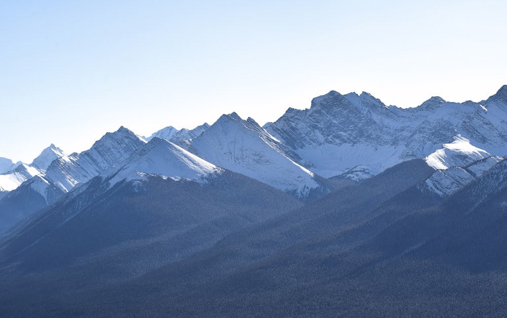 a mountain range with snow covered mountains in the background