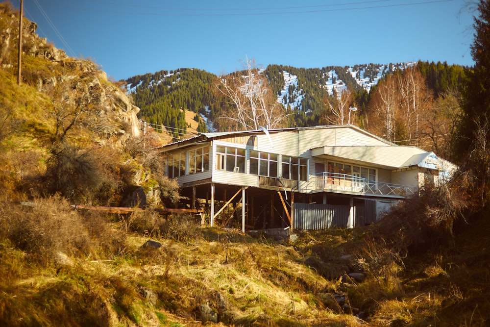 a large house sitting on top of a lush green hillside