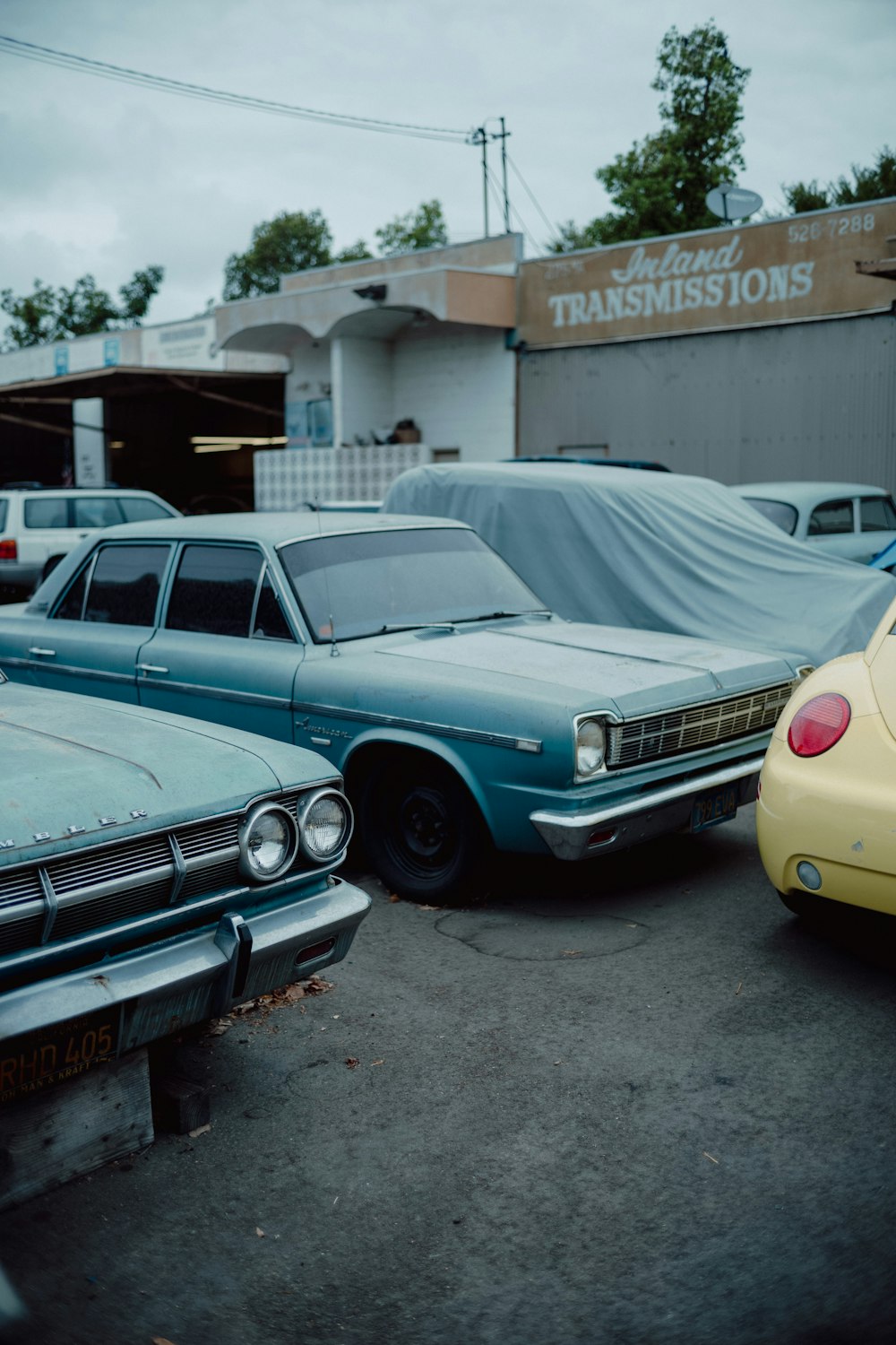 a couple of cars parked next to each other in a parking lot