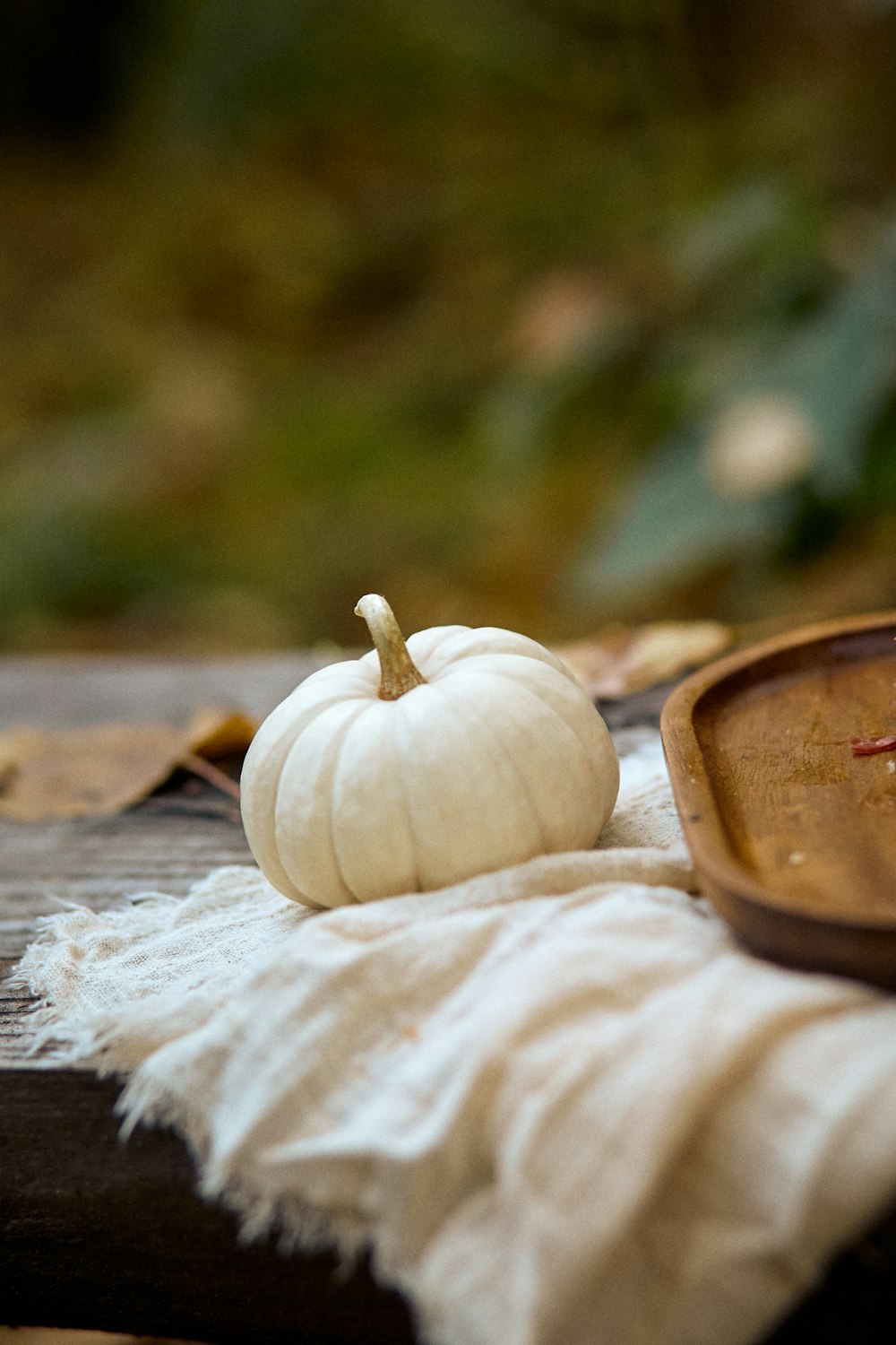 a white pumpkin sitting on top of a wooden table