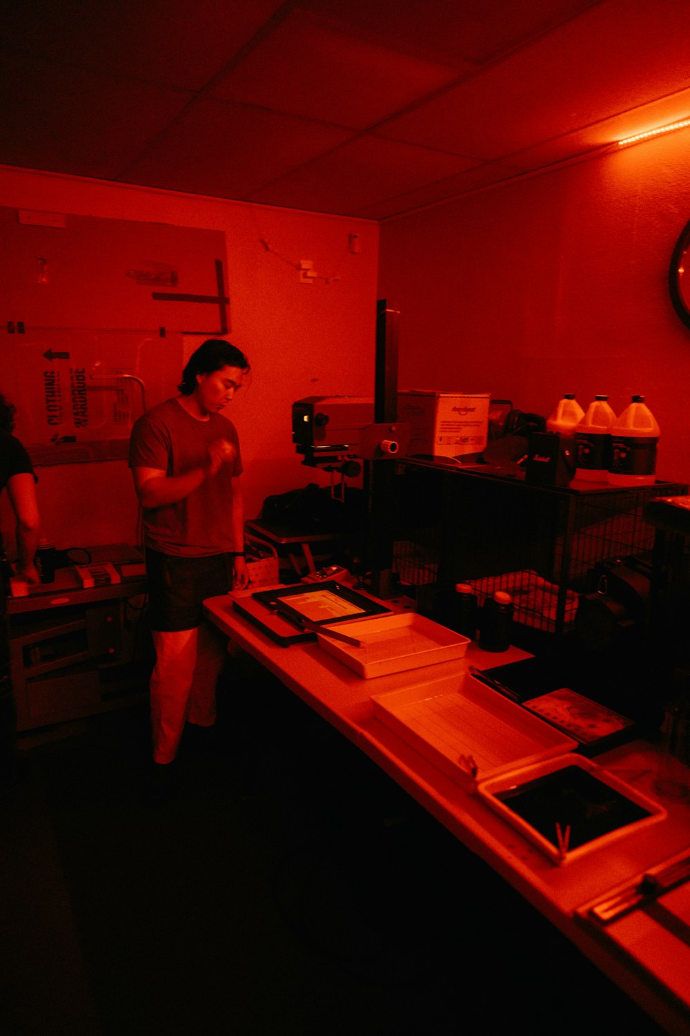 a man standing in a room with a red light