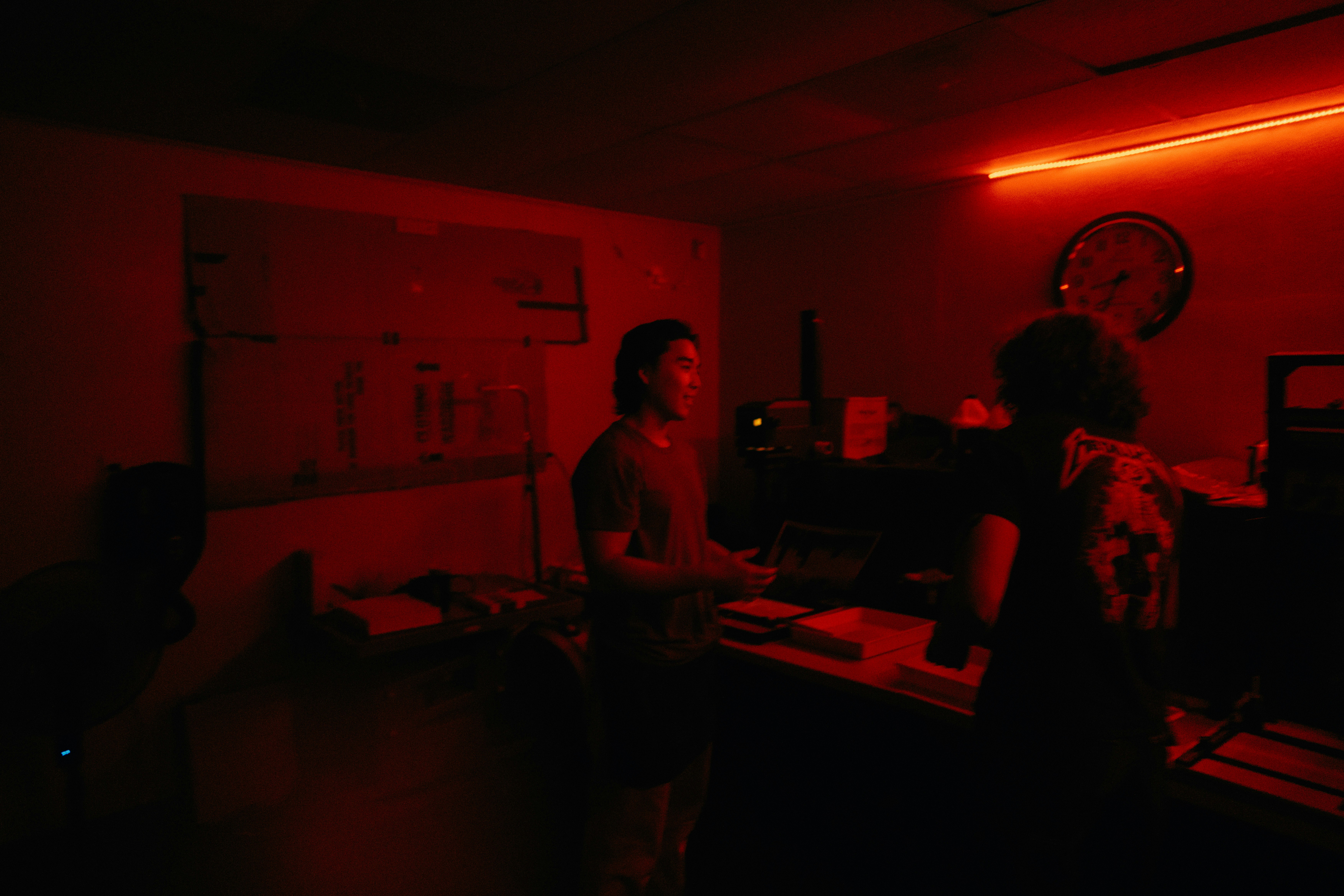 a couple of people standing in a dark room