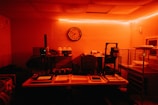 a dimly lit room with a clock on the wall