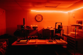 a dimly lit room with a clock on the wall