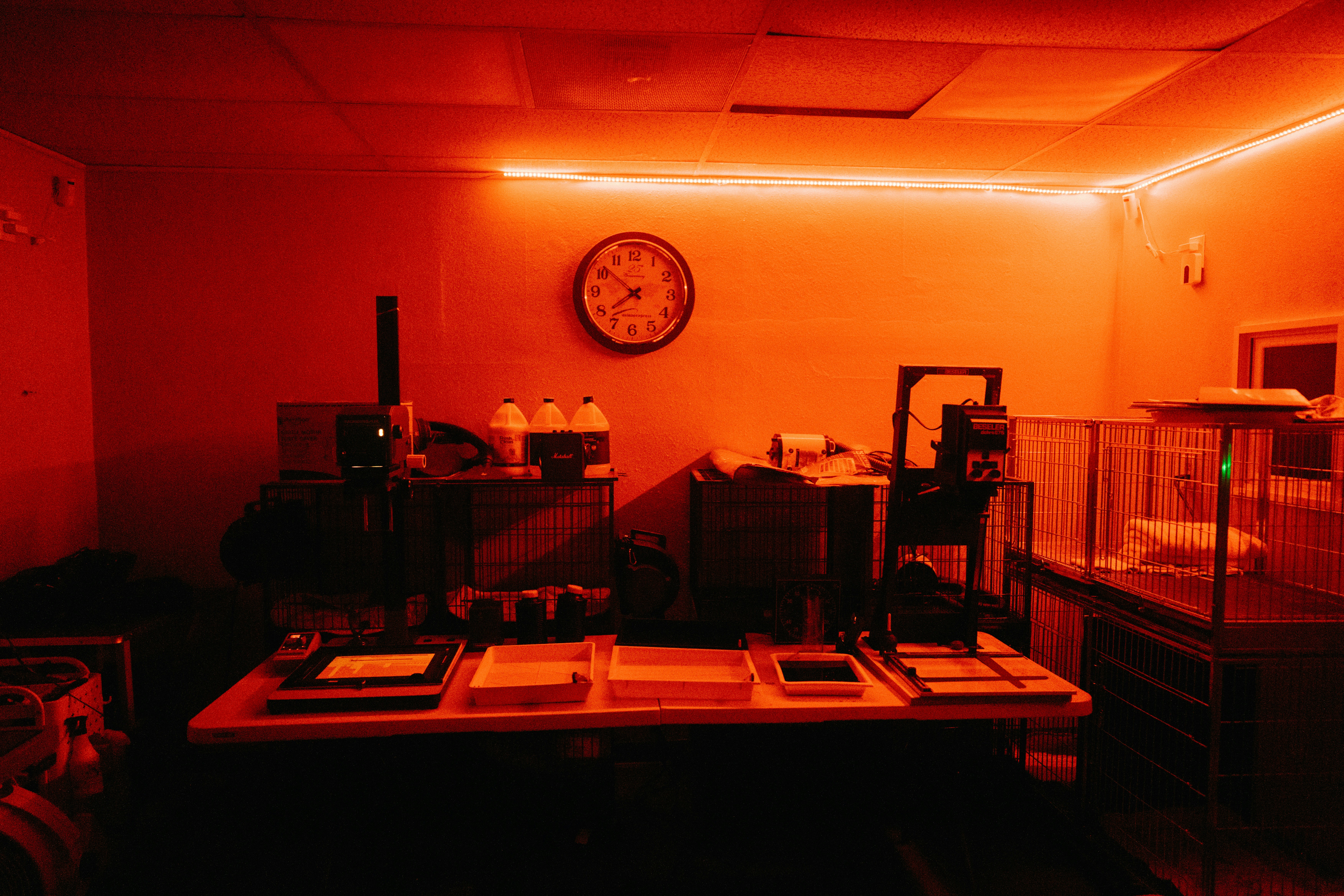 a dimly lit room with a clock on the wall