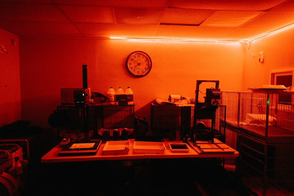 a dimly lit room with a clock on the wall