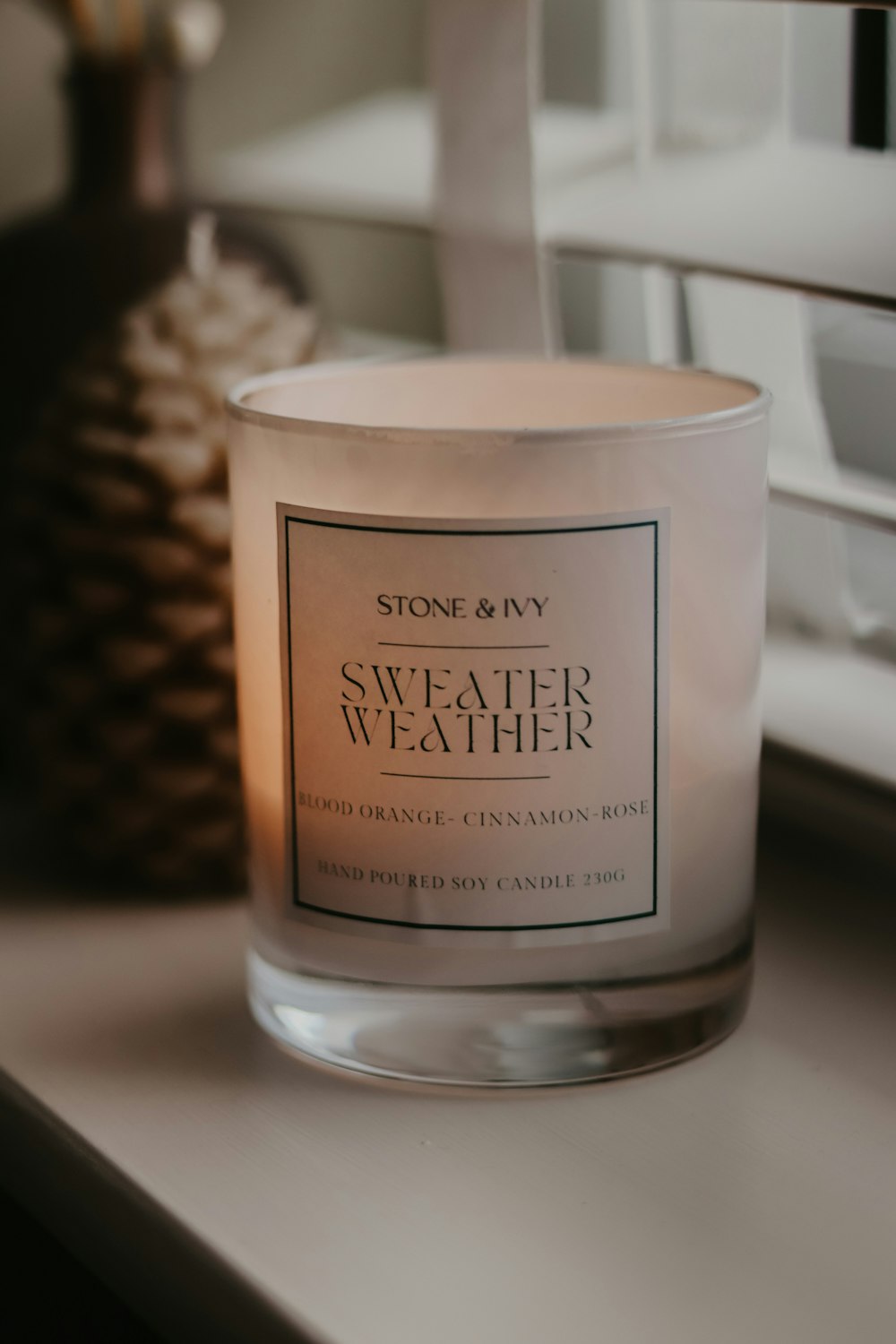 a white candle sitting on top of a counter