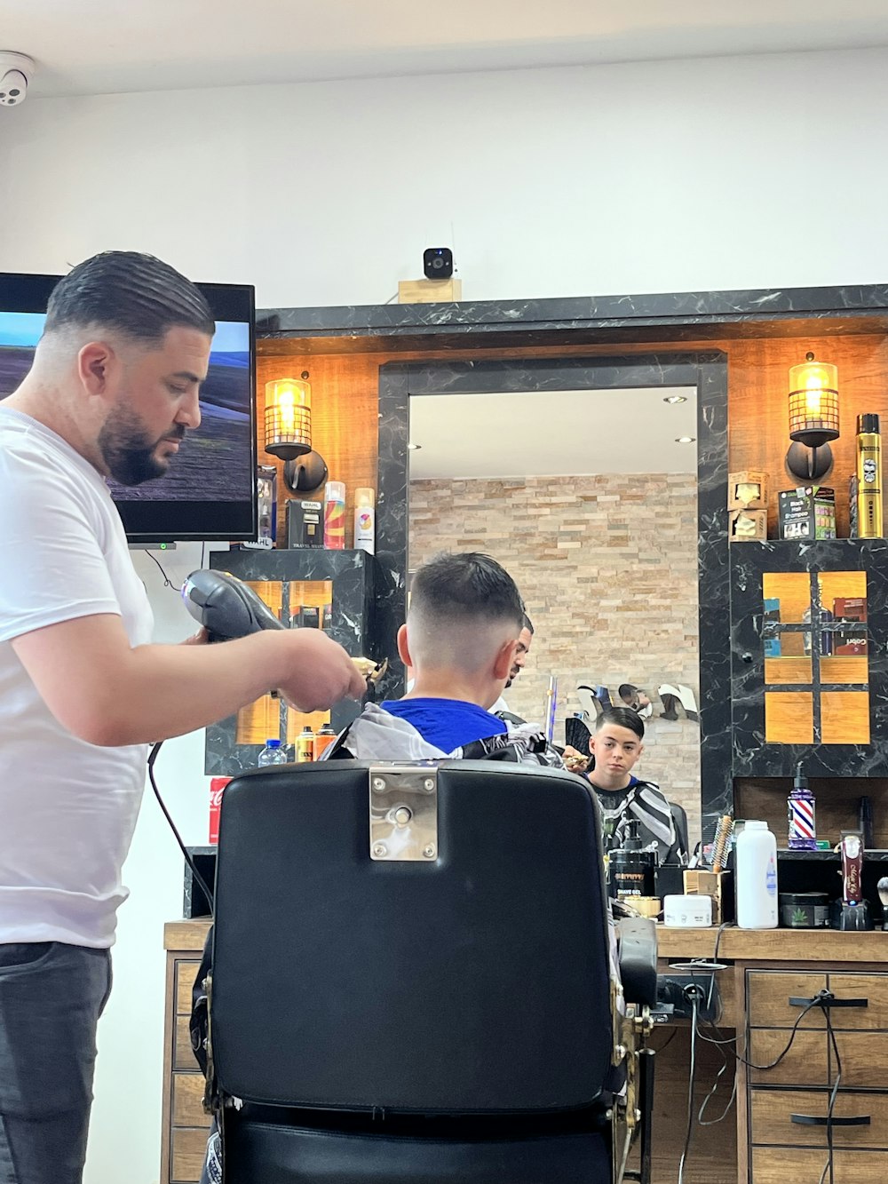 a man getting his hair cut at a barber shop