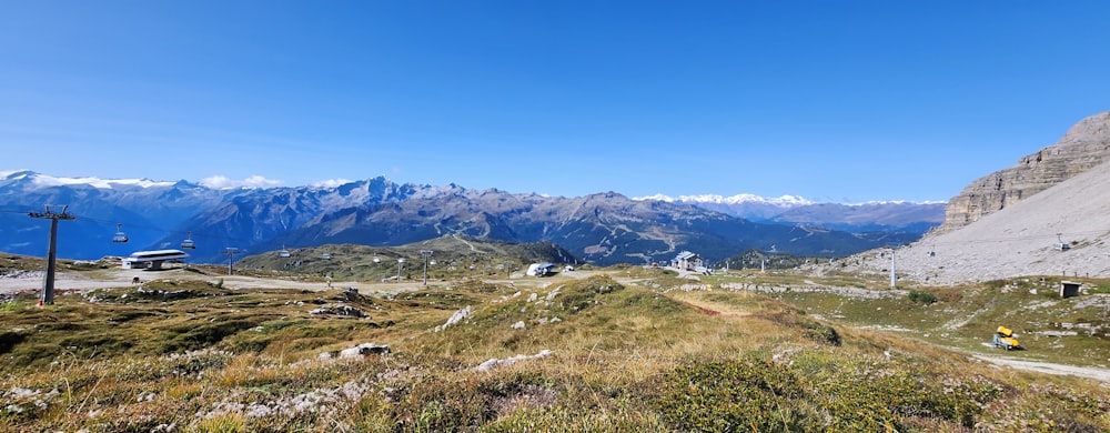 a scenic view of a mountain range with a road in the foreground