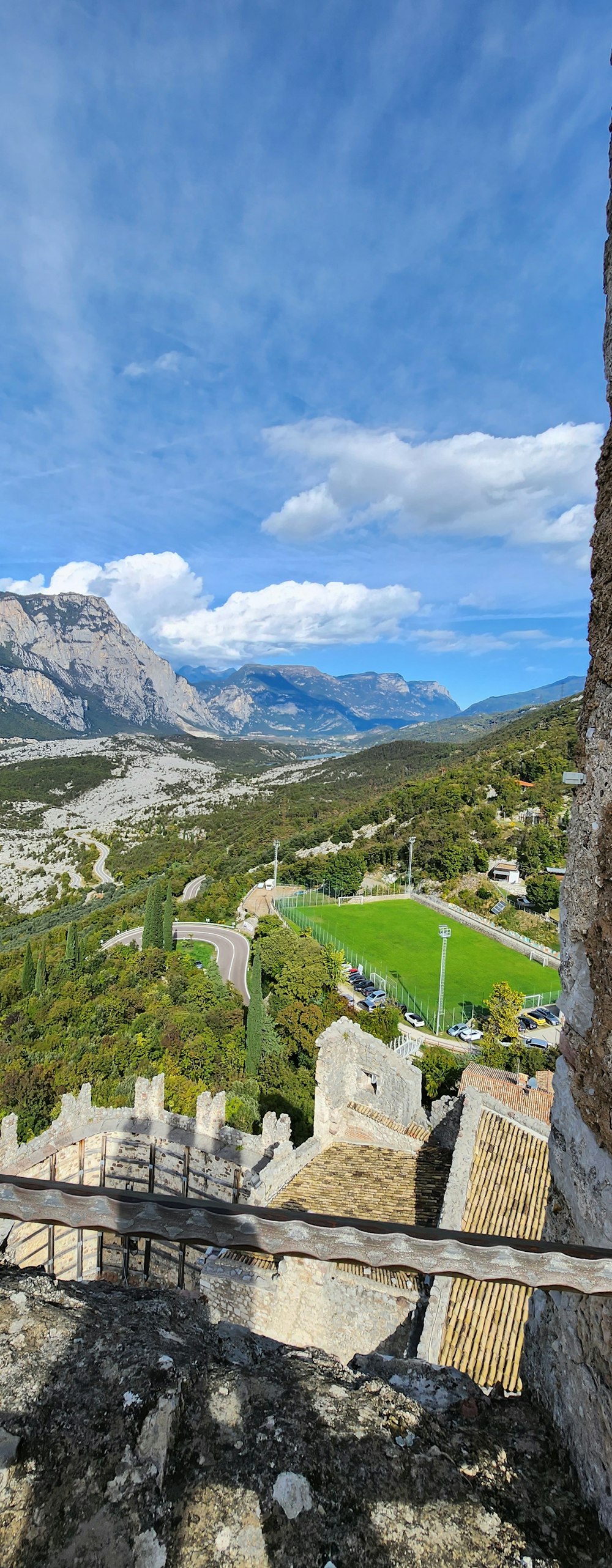 a view of a valley and mountains from the top of a hill