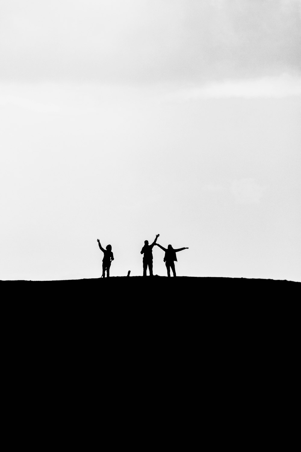 a group of people standing on top of a hill