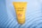 A yellow tube of Lakmé Sun Expert Ultra Matte Lotion is submerged in clear water. The tube displays information about its SPF 24 and PA rating.