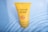 A yellow tube of Lakmé Sun Expert Ultra Matte Lotion is submerged in clear water. The tube displays information about its SPF 24 and PA rating.