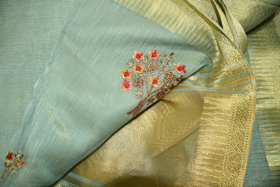 Close-up of intricate embroidery and fine fabric textures on a classic saree.