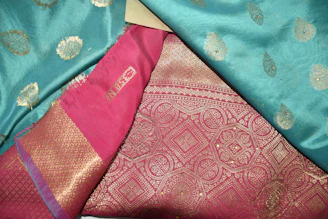 Vibrant designer salwar suit featuring intricate patterns and royal gold accents.