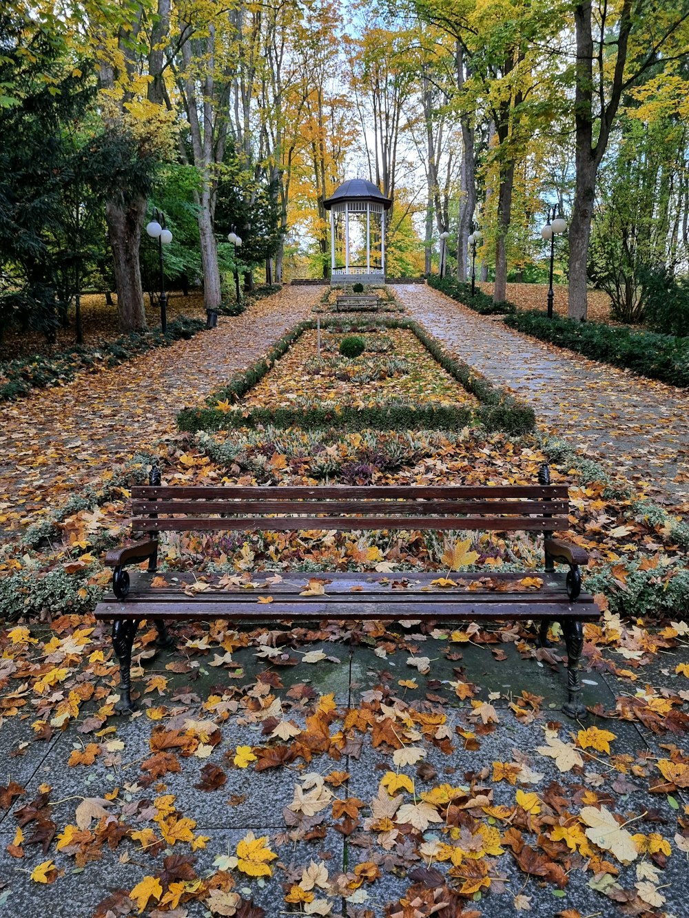 a wooden bench sitting in the middle of a park