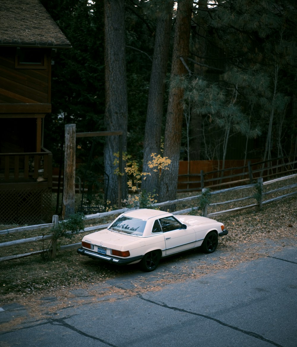 a white car parked on the side of the road