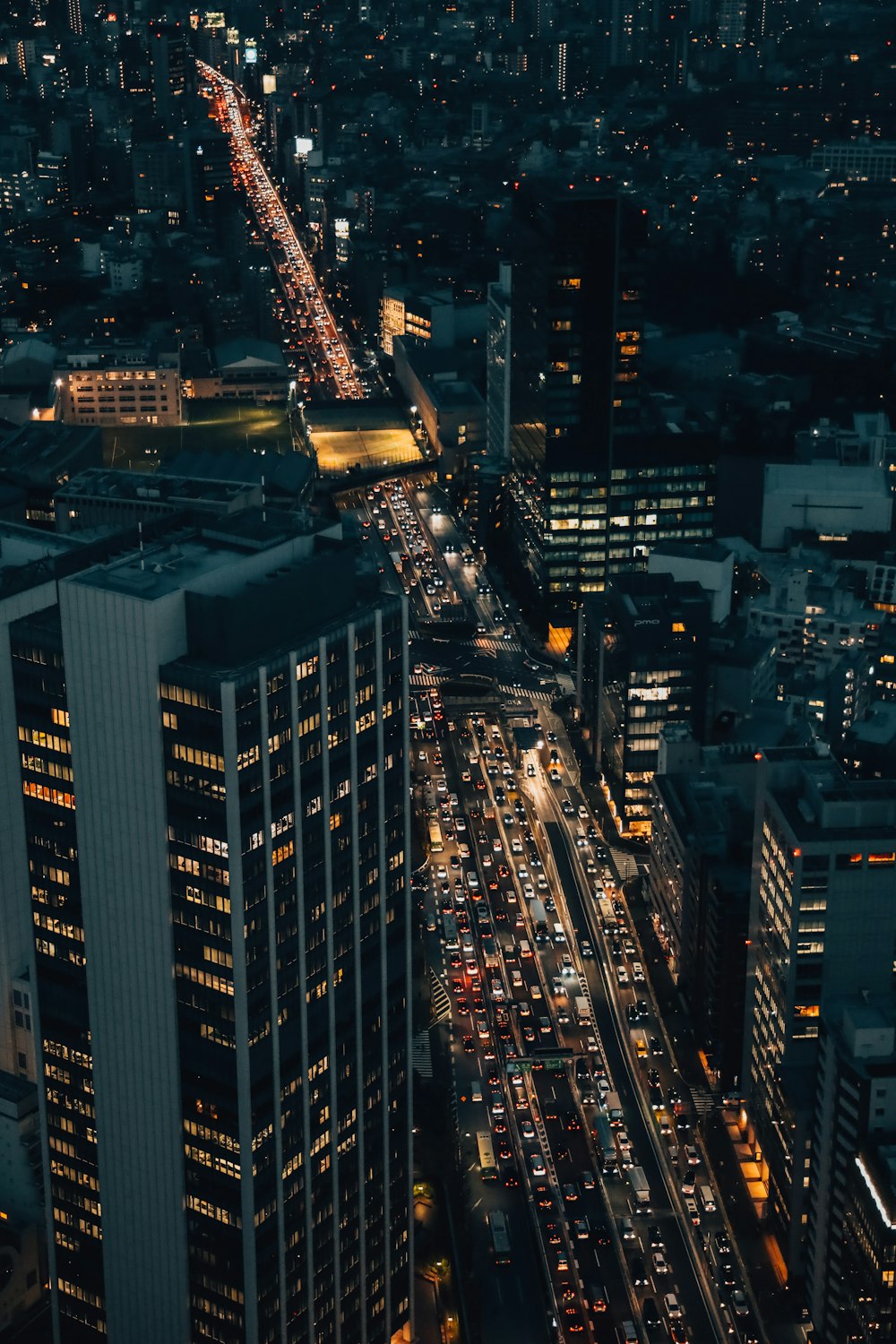 a city street filled with lots of traffic at night