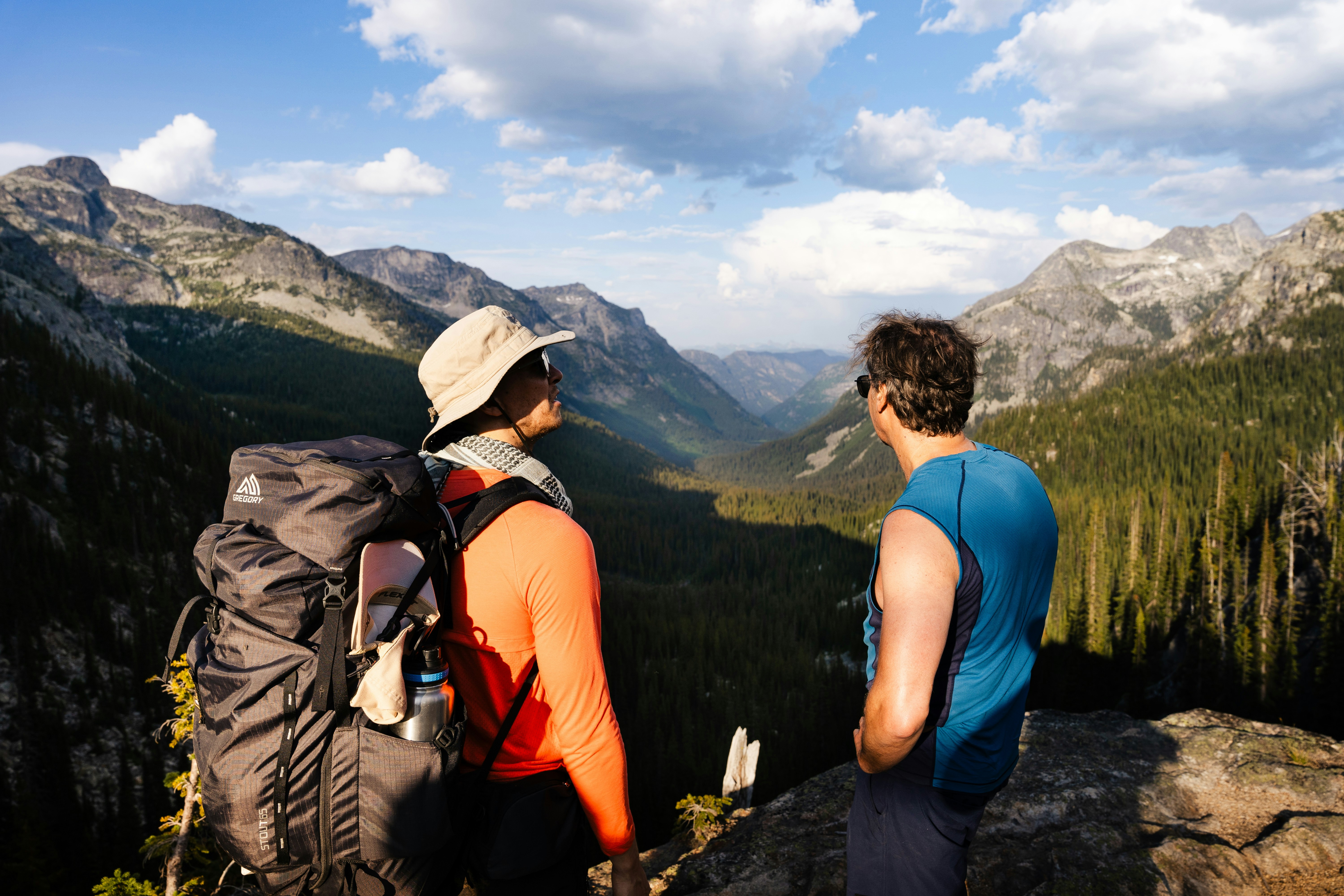A couple of men standing on top of a mountain photo – Free Bc Image on ...