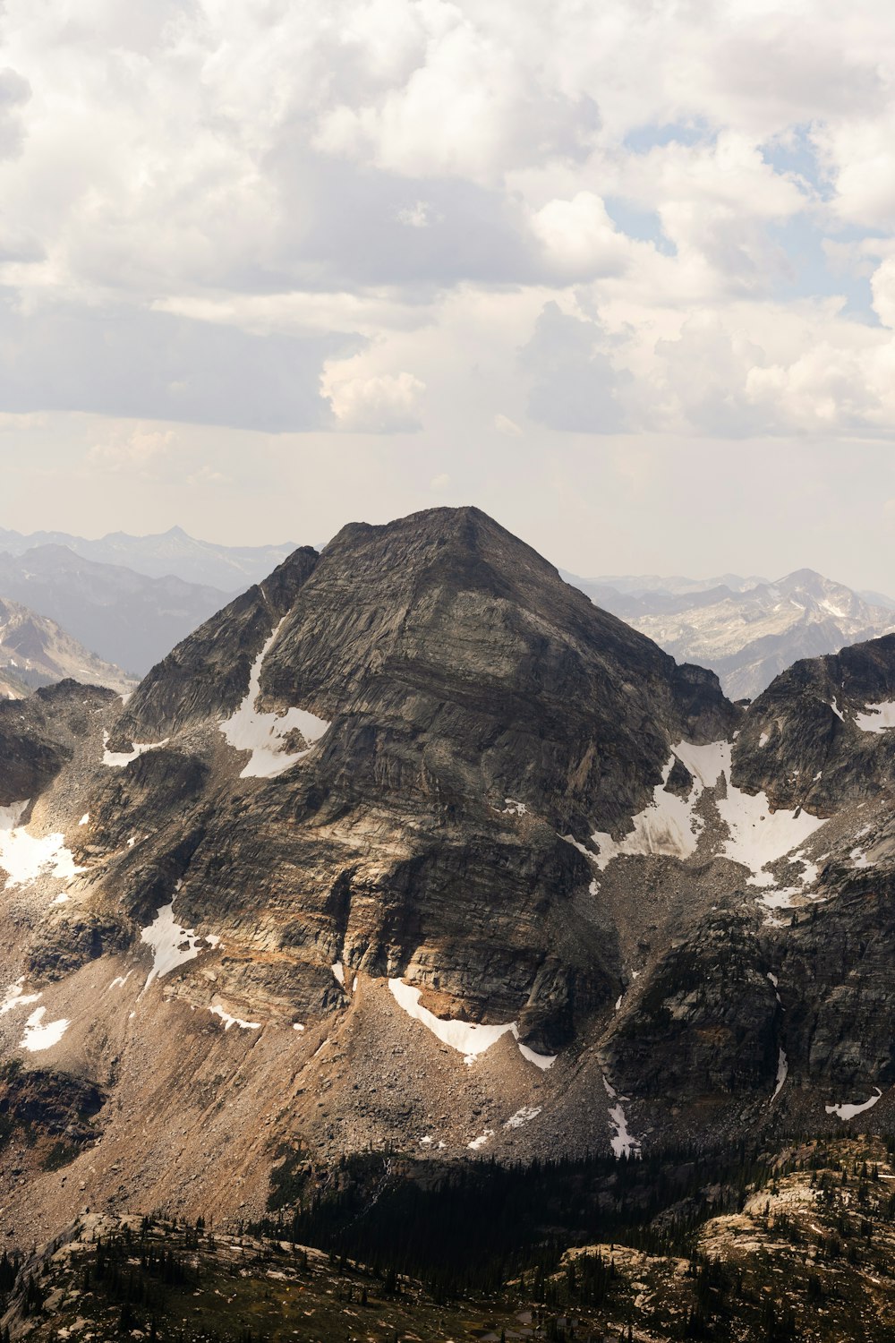 a view of a mountain range with snow on it