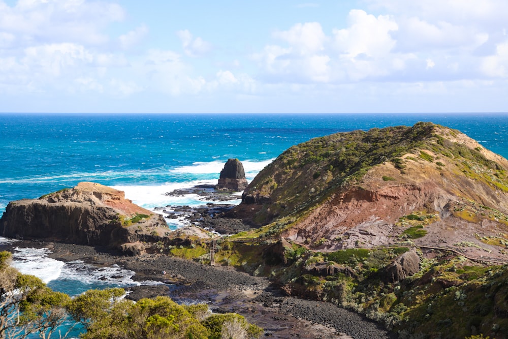 a view of the ocean from the top of a hill