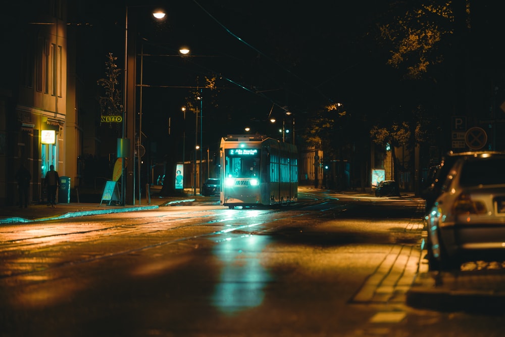 a city bus on a city street at night