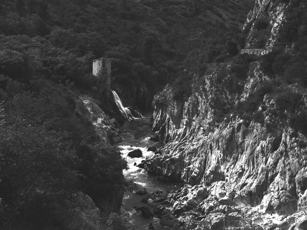 a black and white photo of a mountain stream