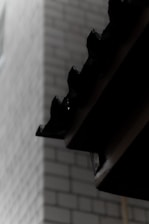 Close-up of a professional applying waterproofing sealant on a residential roof