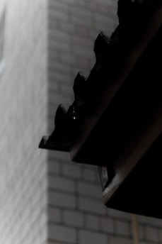 Close-up of waterproofing membrane being installed on a building foundation.