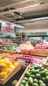 a produce section of a grocery store filled with fruits and vegetables