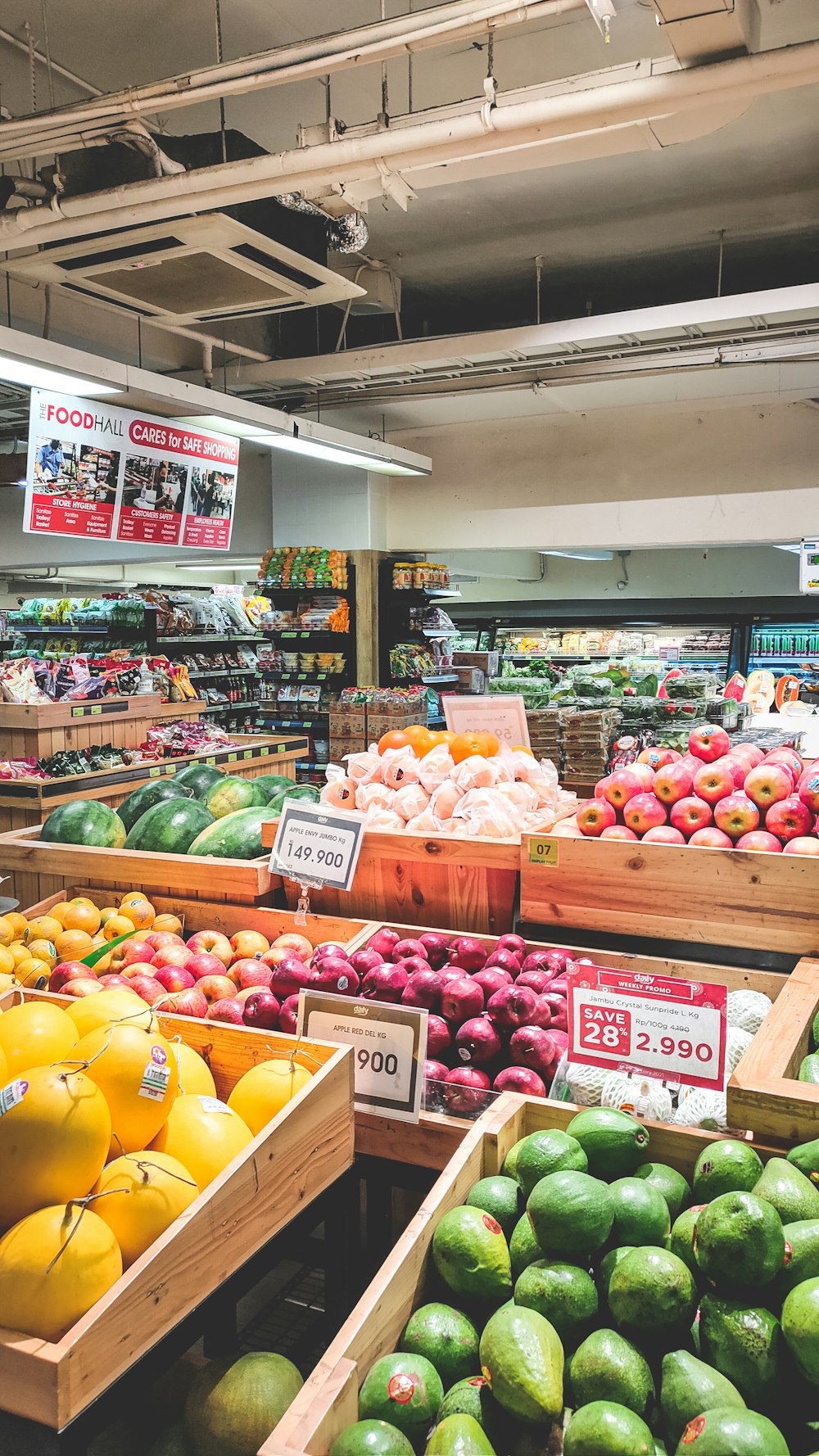 a produce section of a grocery store filled with fruits and vegetables